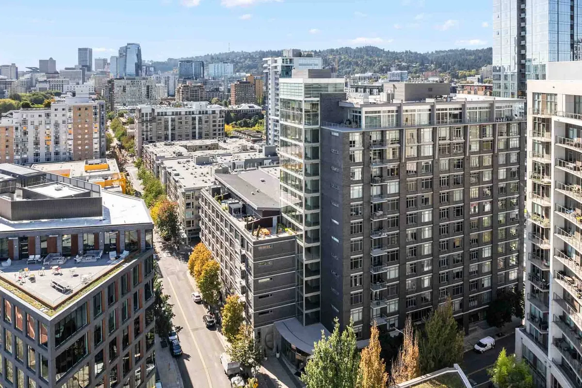 A dynamic cityscape with modern skyscrapers, contemporary buildings, and leafy, tree-lined streets. Outdoor diners and shoppers animate the scene, conveying the energy and accessibility of urban life in this sought-after neighborhood.
